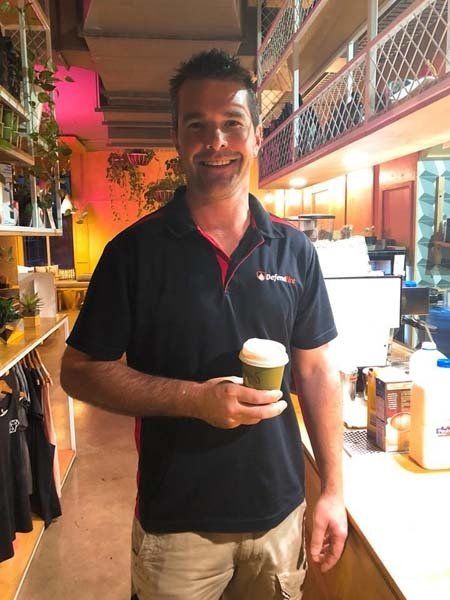 defend fire man holding coffee