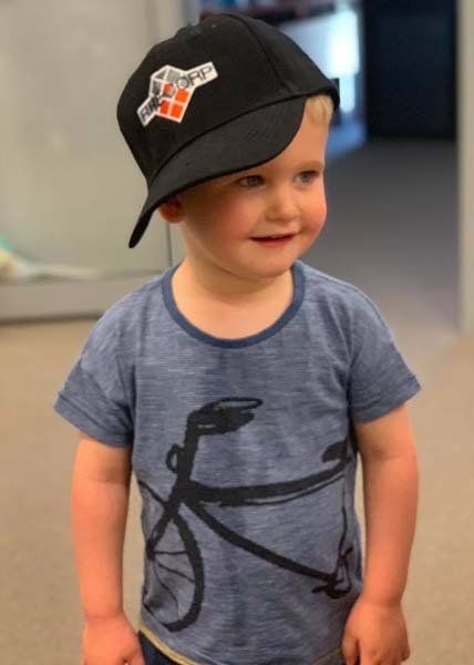 young boy wearing defend fire hat