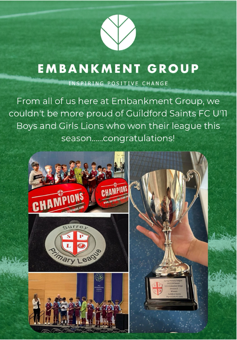 A person is holding a trophy on a green field.