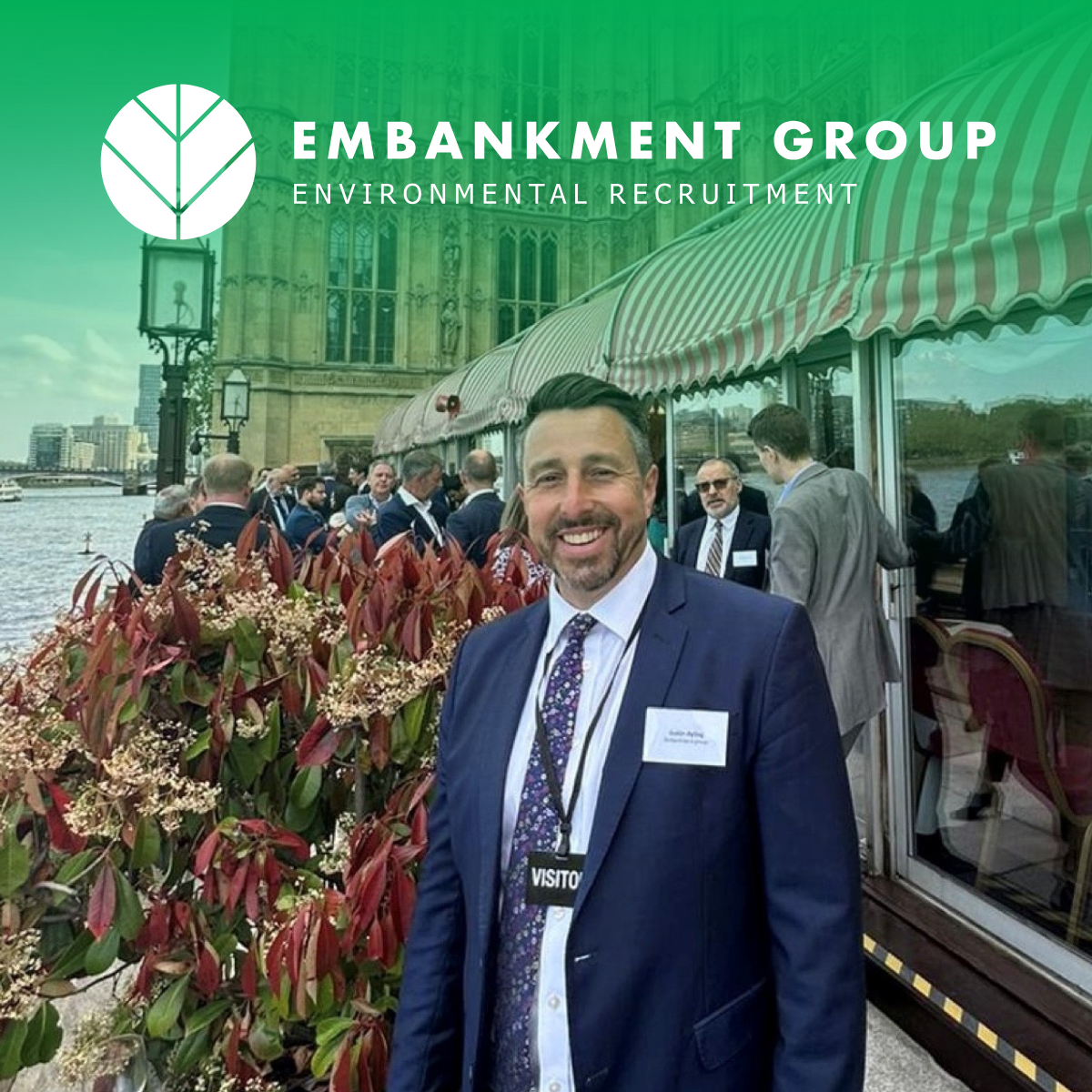 Ecology recruiter smiling at outdoor event beside train, with Embankment Group logo overlay