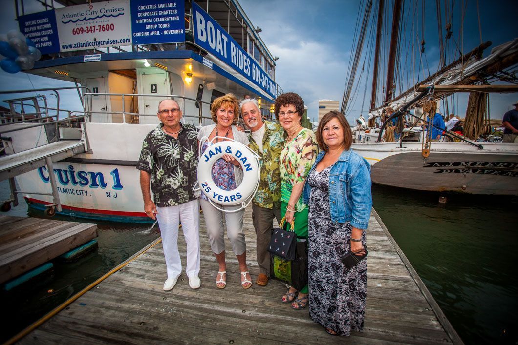 Group of people posing by boat 