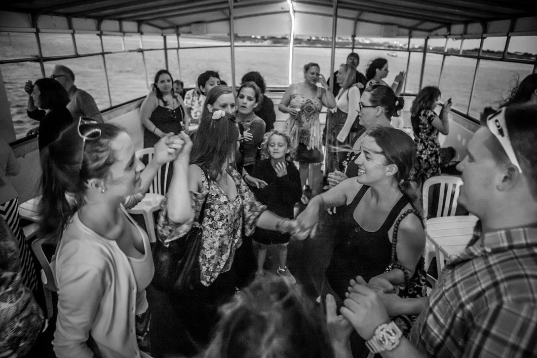 People dancing and socializing on a boat.