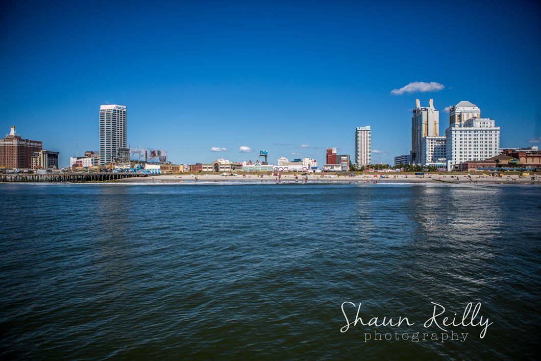 Atlantic City skyline along the ocean under a clear blue sky.