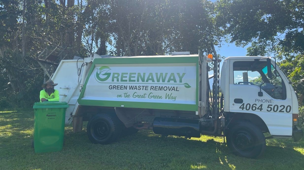 A Garbage Truck With a Worker Next to a Green Bin — Greenaway Green Waste Removal in O'Briens Hill, QLD