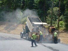 Worker with paving truck at work - Asphalt Paving in Lynnwood, Washington