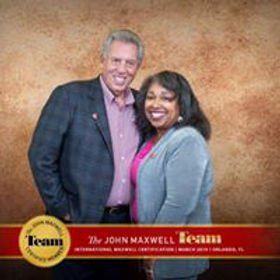 John Maxwell and woman smiling, in front of a brown background, with team certification logo.