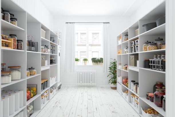 It is a pantry with lots of shelves and a window.