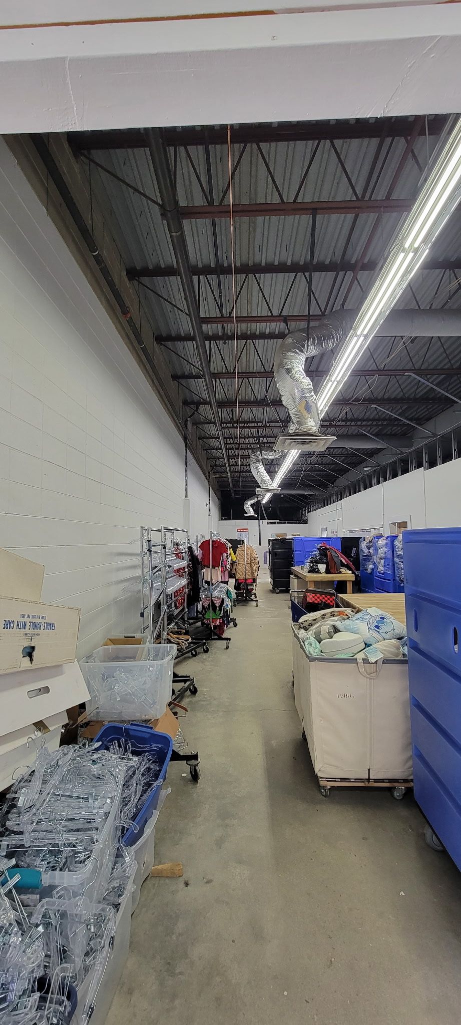 A warehouse filled with lots of containers and boxes.