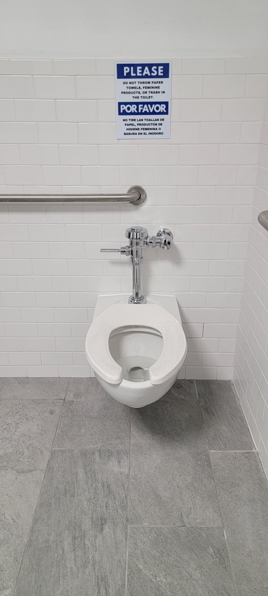 A white toilet is hanging from the wall in a bathroom.