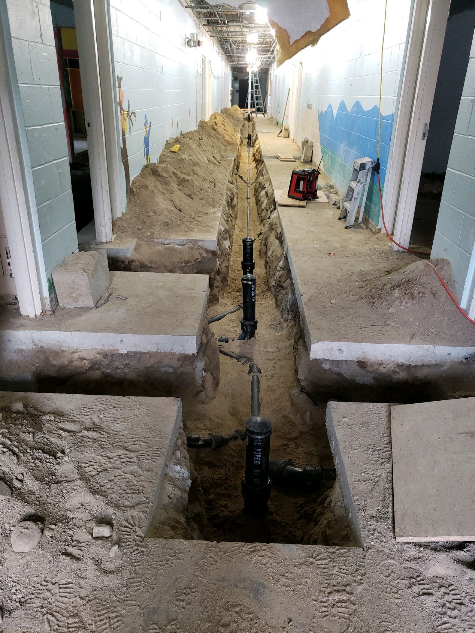 A drain pipe is being installed in a building.