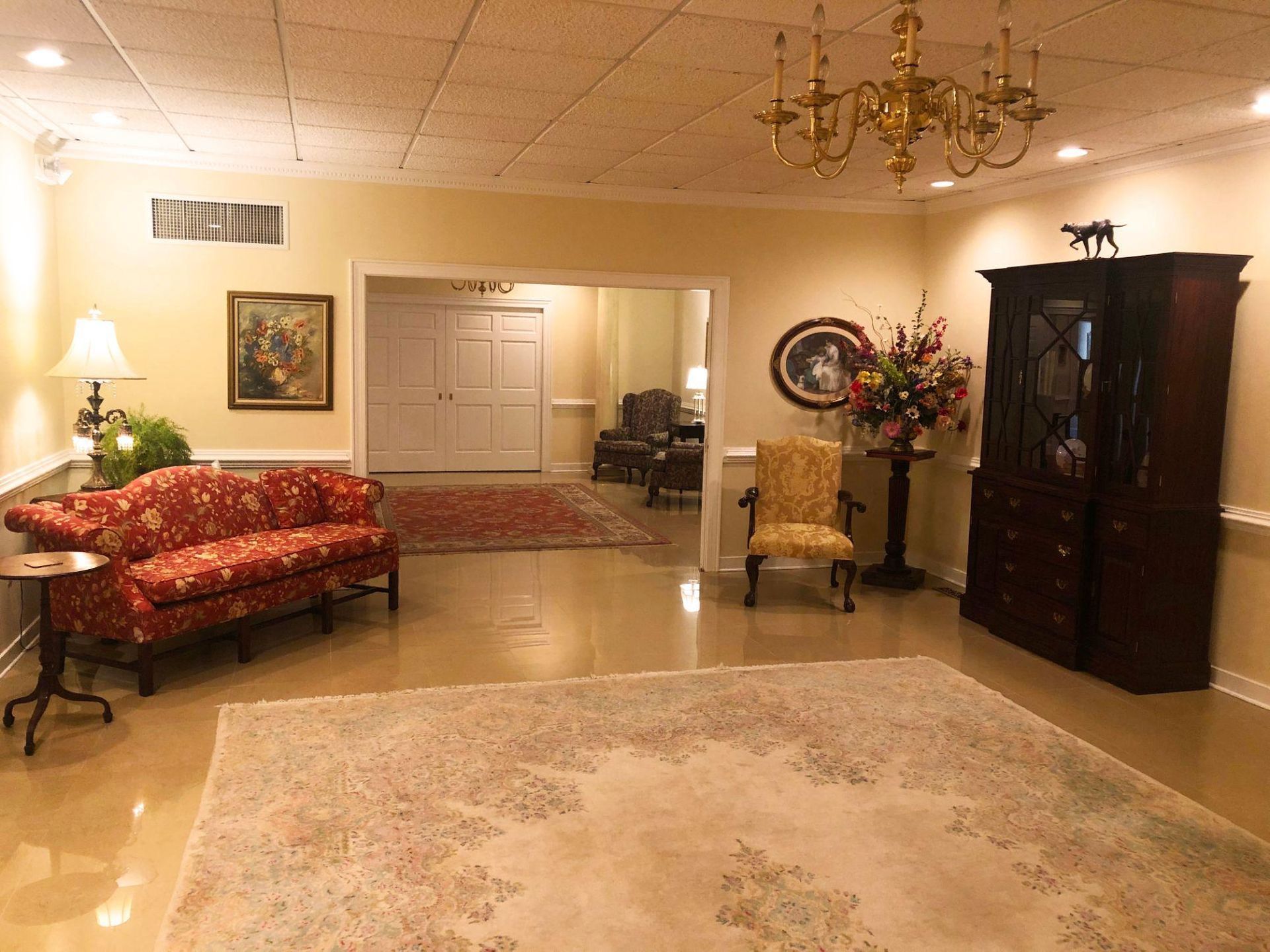 A living room with a couch and chairs and a rug
