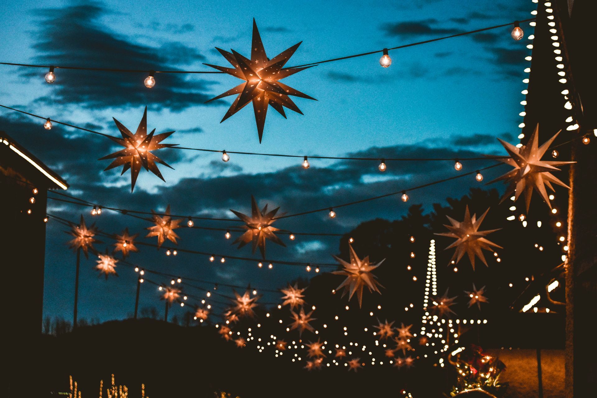 A string of Christmas lights with stars hanging from the ceiling