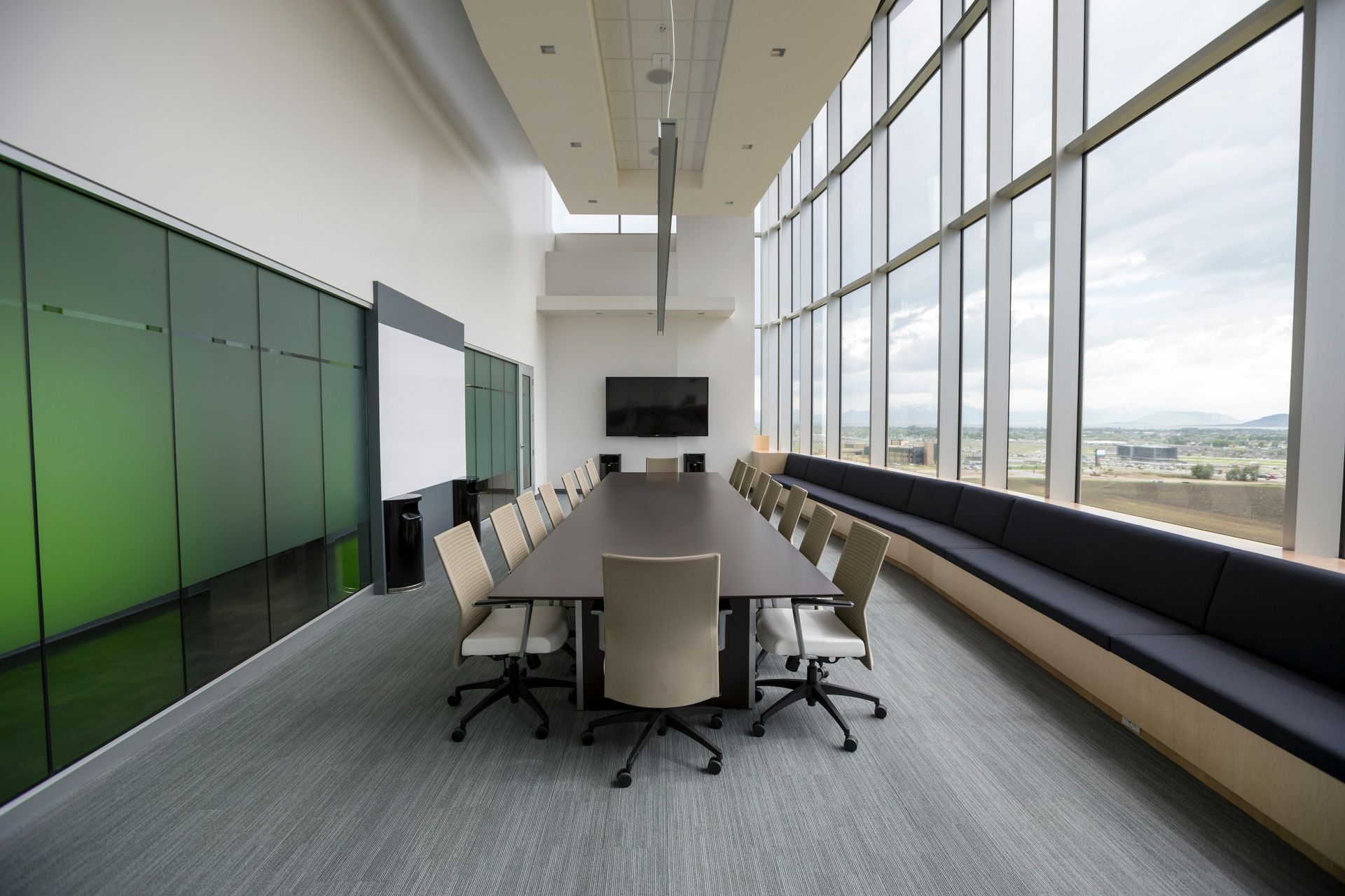 A large conference room with a long table and chairs.