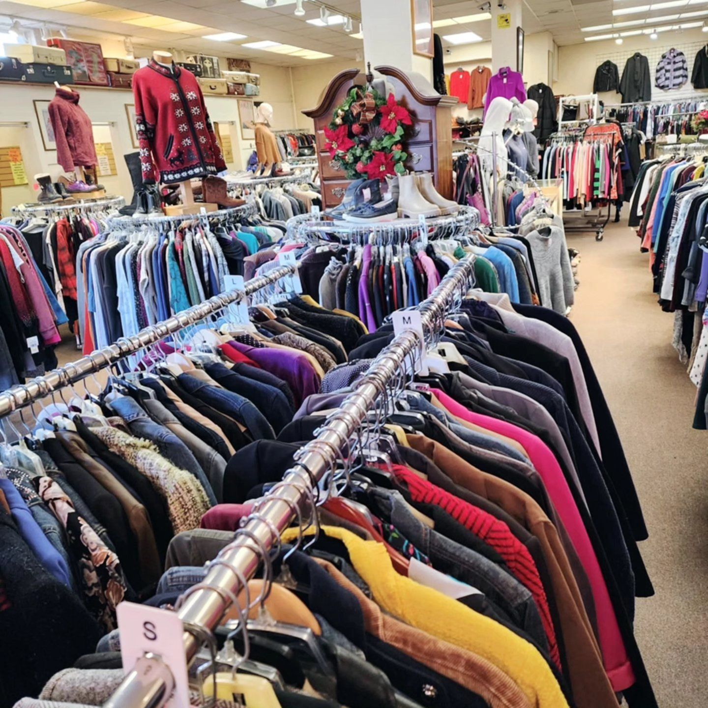 A store filled with lots of clothes and a sign that says $