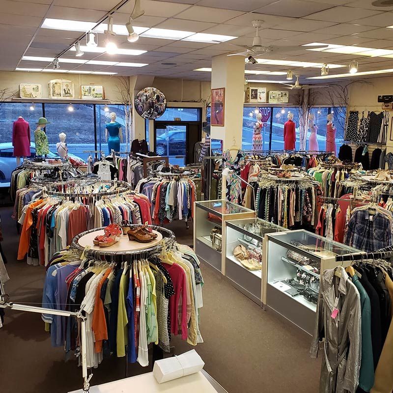 A clothing store with a lot of clothes on display