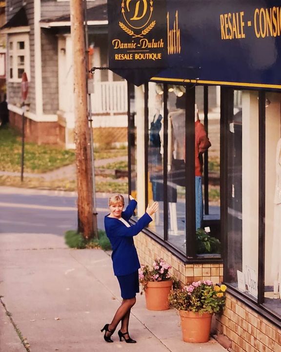 A woman stands in front of a regale boutique