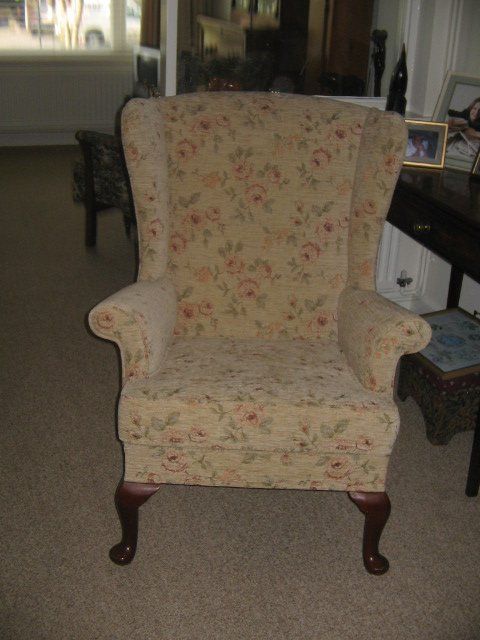a light coloured floral design armchair