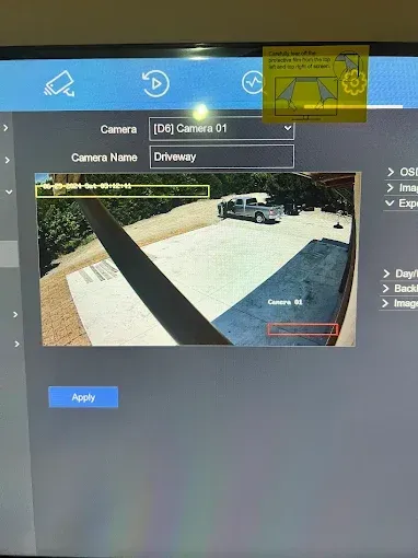 Surveillance camera interface displaying a driveway with a truck, and a setting adjustment screen.