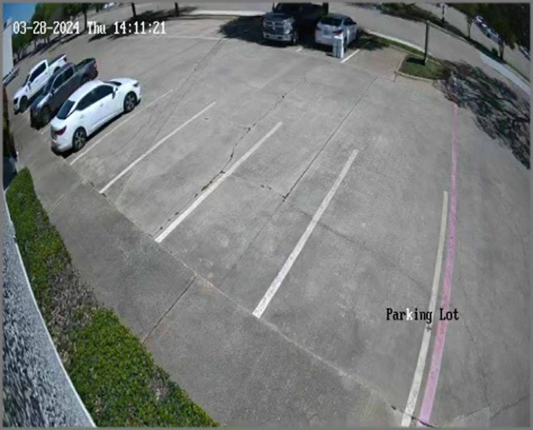 Parking lot with parked cars, mostly empty spaces. Date/time stamp: 03-20-2024 14:11:21. 