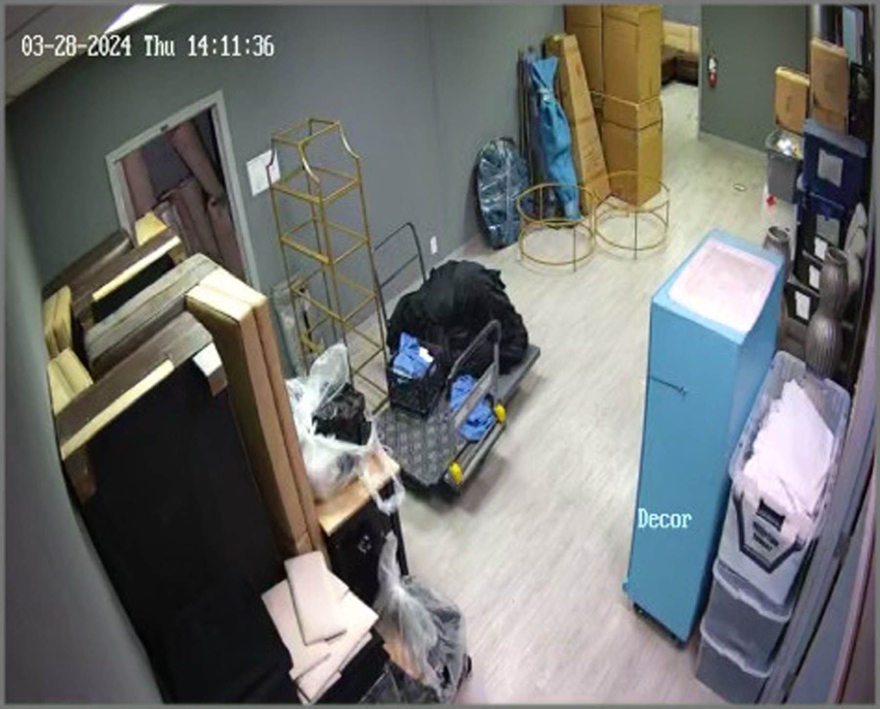 Warehouse storage room with furniture, boxes, and decor. Timestamp: March 20, 2024.