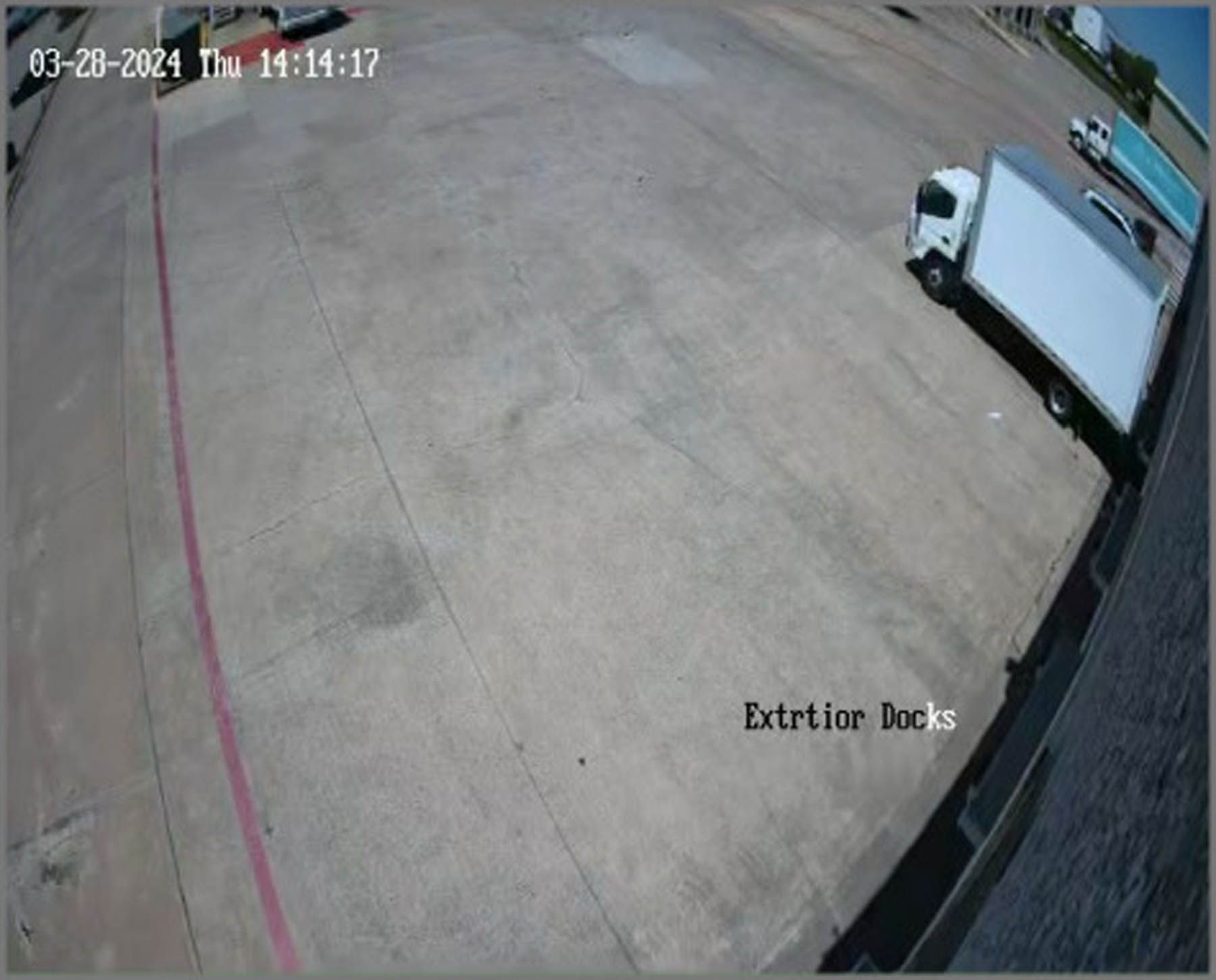 A white delivery truck parked on a concrete lot, timestamped 03-20-2024.