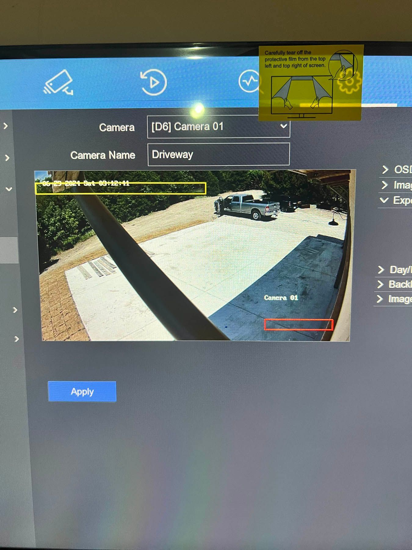 Screenshot of a security camera interface showing an outdoor view of a driveway and car, with labeled camera settings.