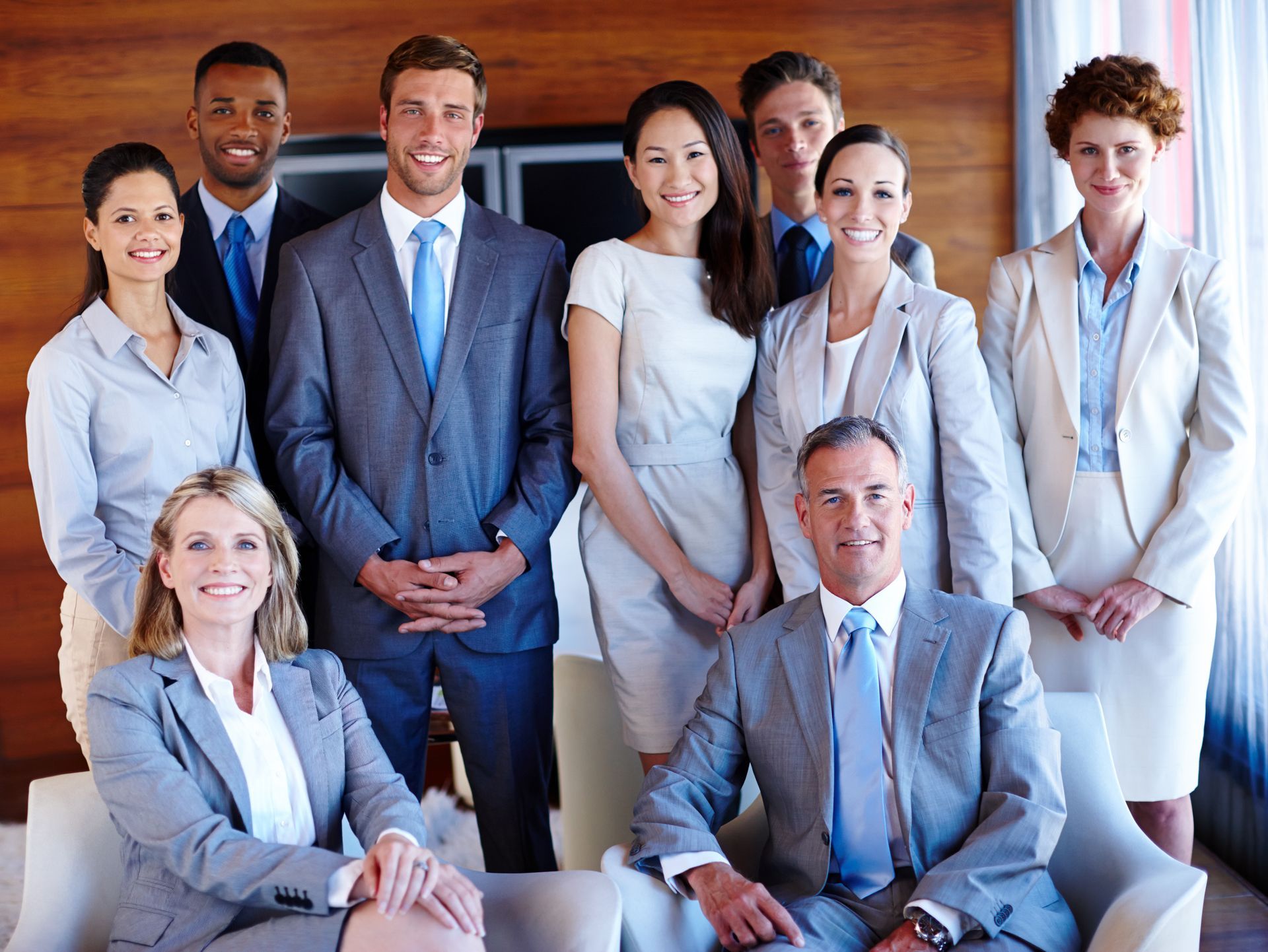 A group of business people are posing for a picture together
