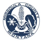 Missoula County, Montana seal: Blue and white design with mountains, tree, snowflake, and Native American profile.