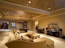 Spacious living room with beige sofa, TV, and pool table; soft lighting and a textured ceiling.