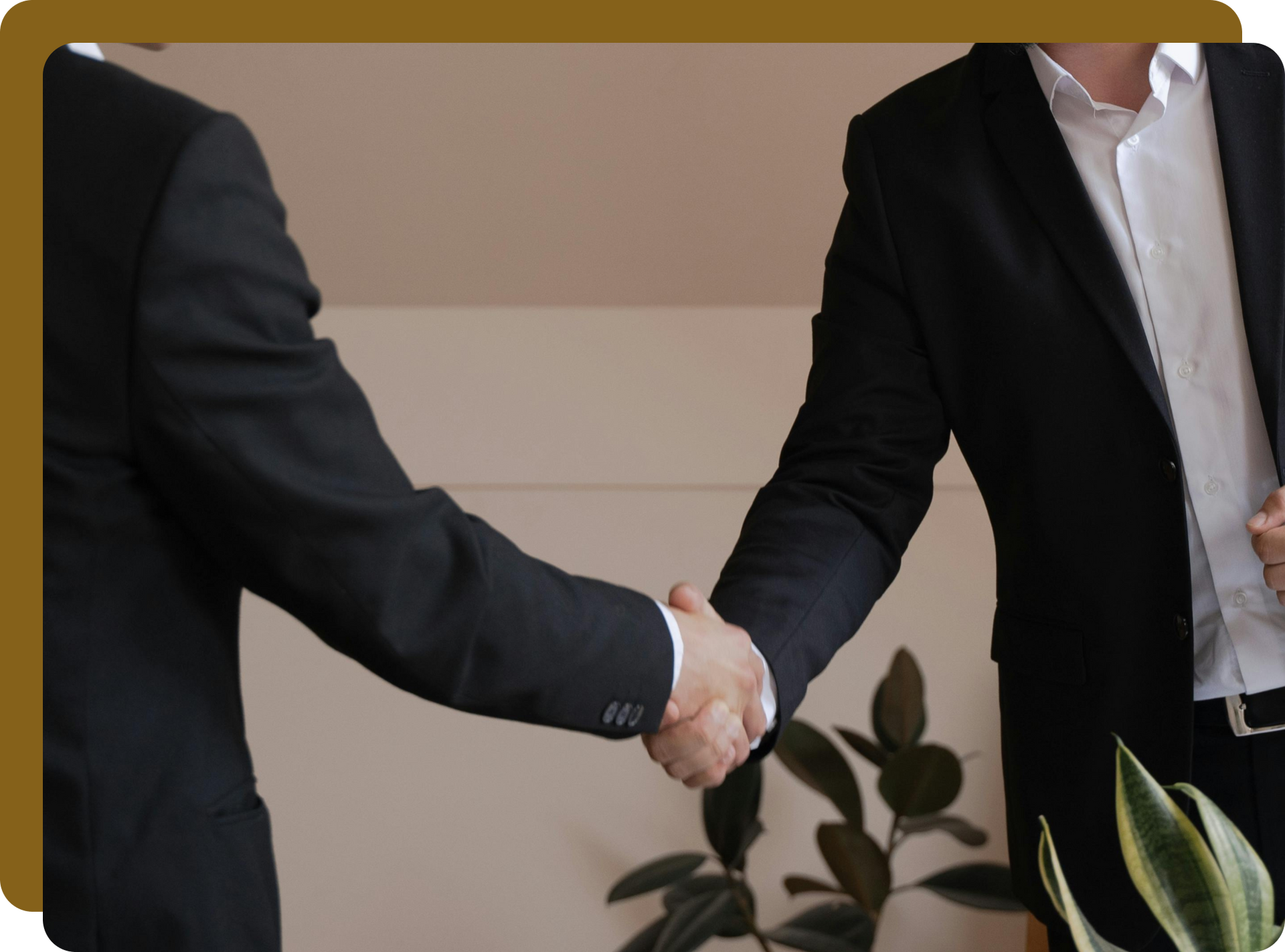 Two men in suits shaking hands, likely in an office setting, symbolizing agreement.