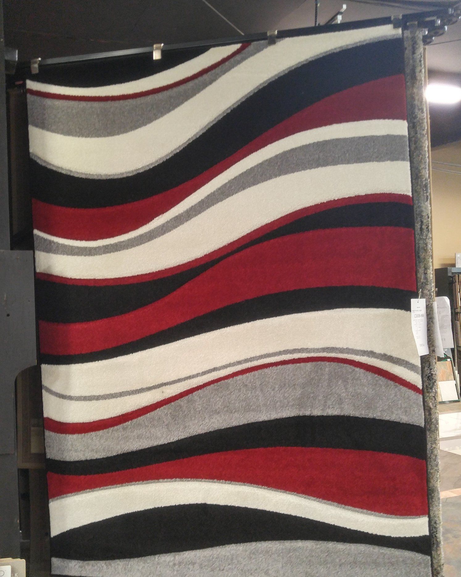 A red black and white rug with waves on it
