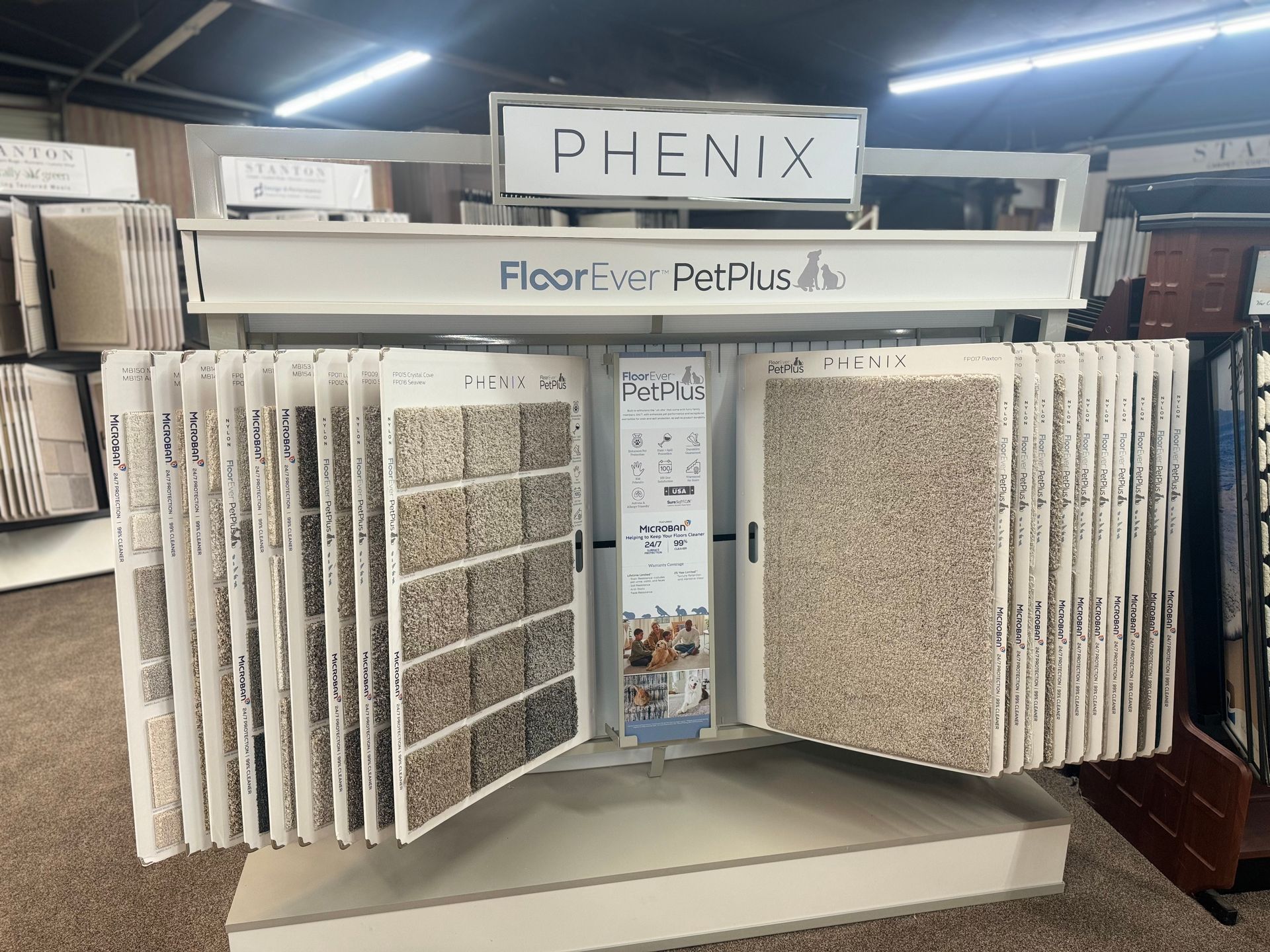 A display of carpets in a store called phenix