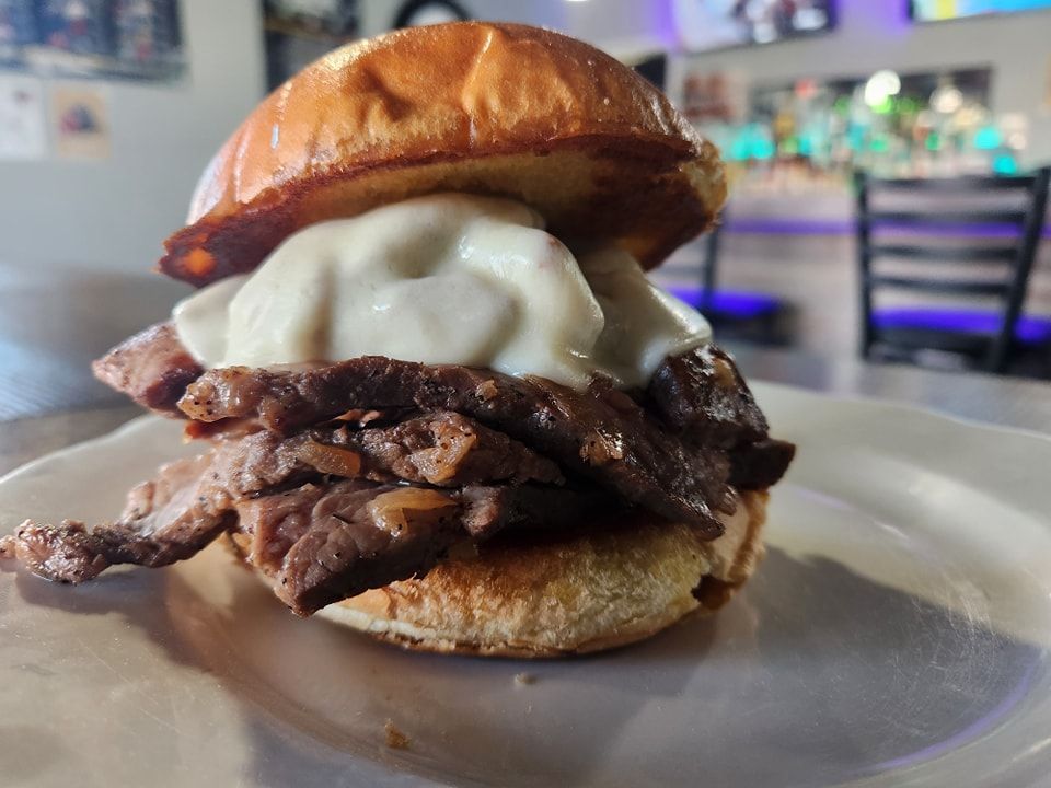 A close up of a sandwich on a plate on a table.
