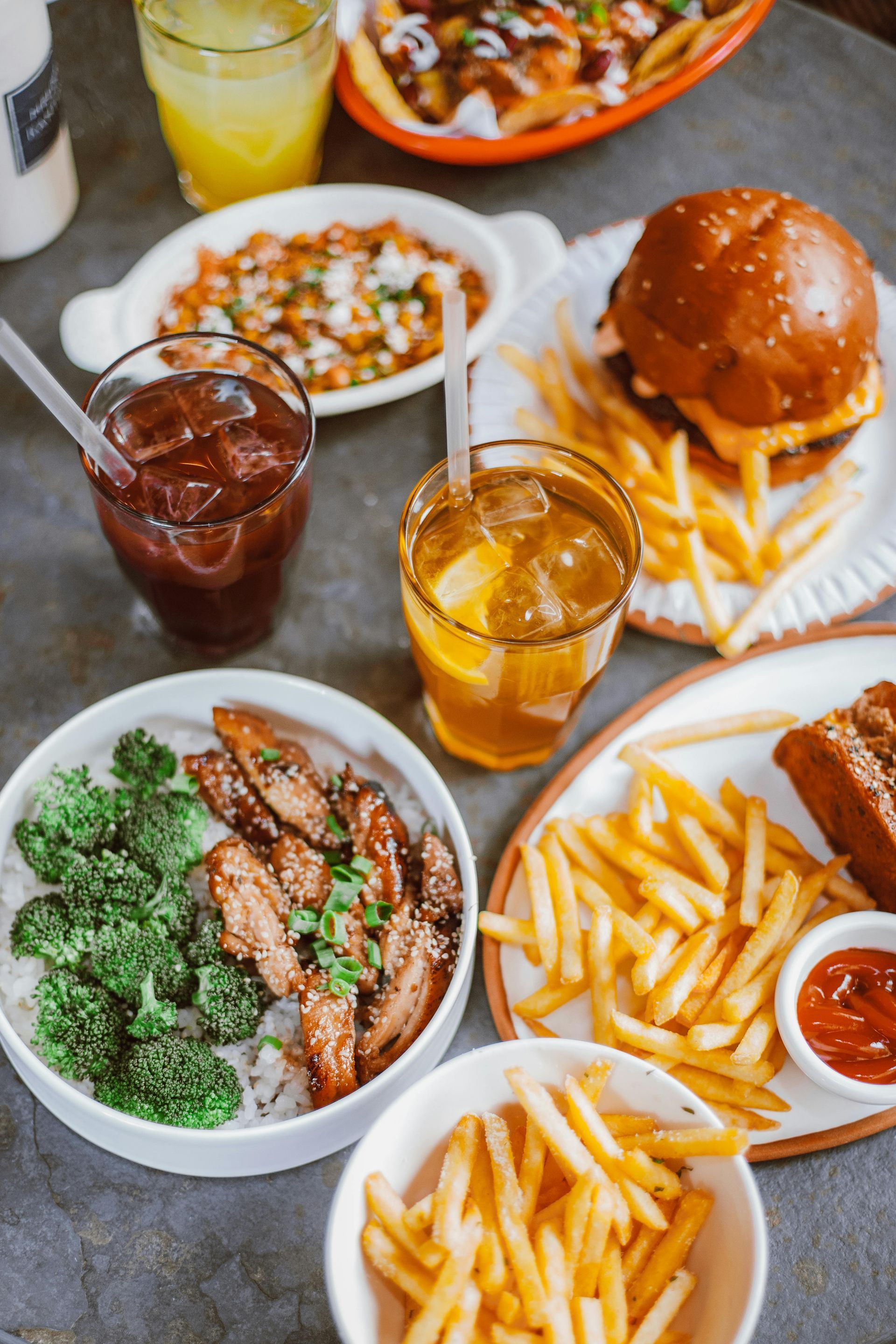 A table topped with plates of food and drinks.