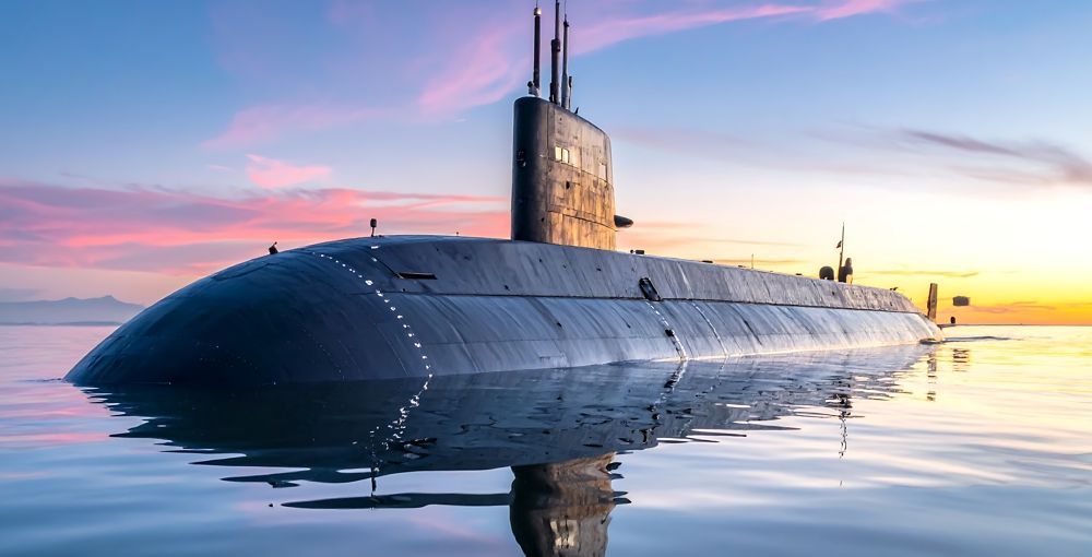 Submarine on the water's surface at sunrise. Reflective water, with a colorful sky.