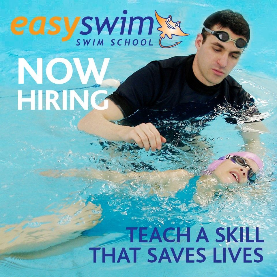 Swim instructor teaching a child in a pool. 