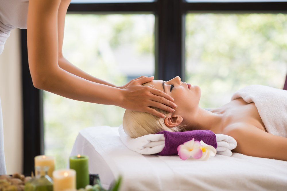 A Woman Is Getting A Head Massage At A Spa — Bathurst JP Thai Massage In Bathurst, NSW