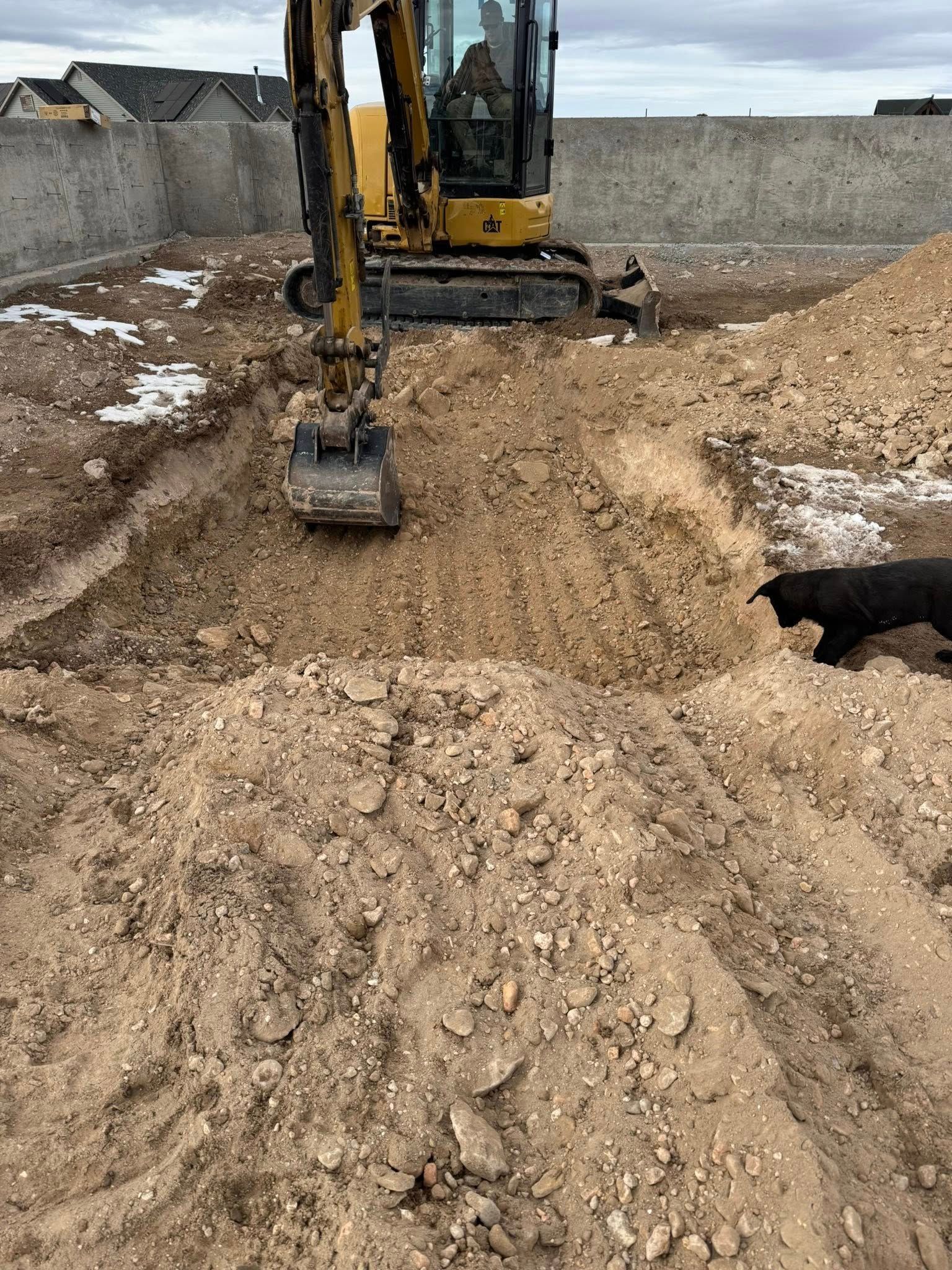 A bulldozer is digging a hole in the dirt.