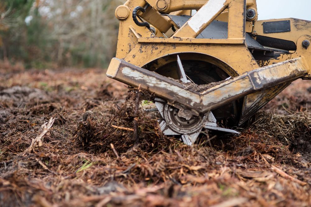 A close up of a machine moving dirt in a field.