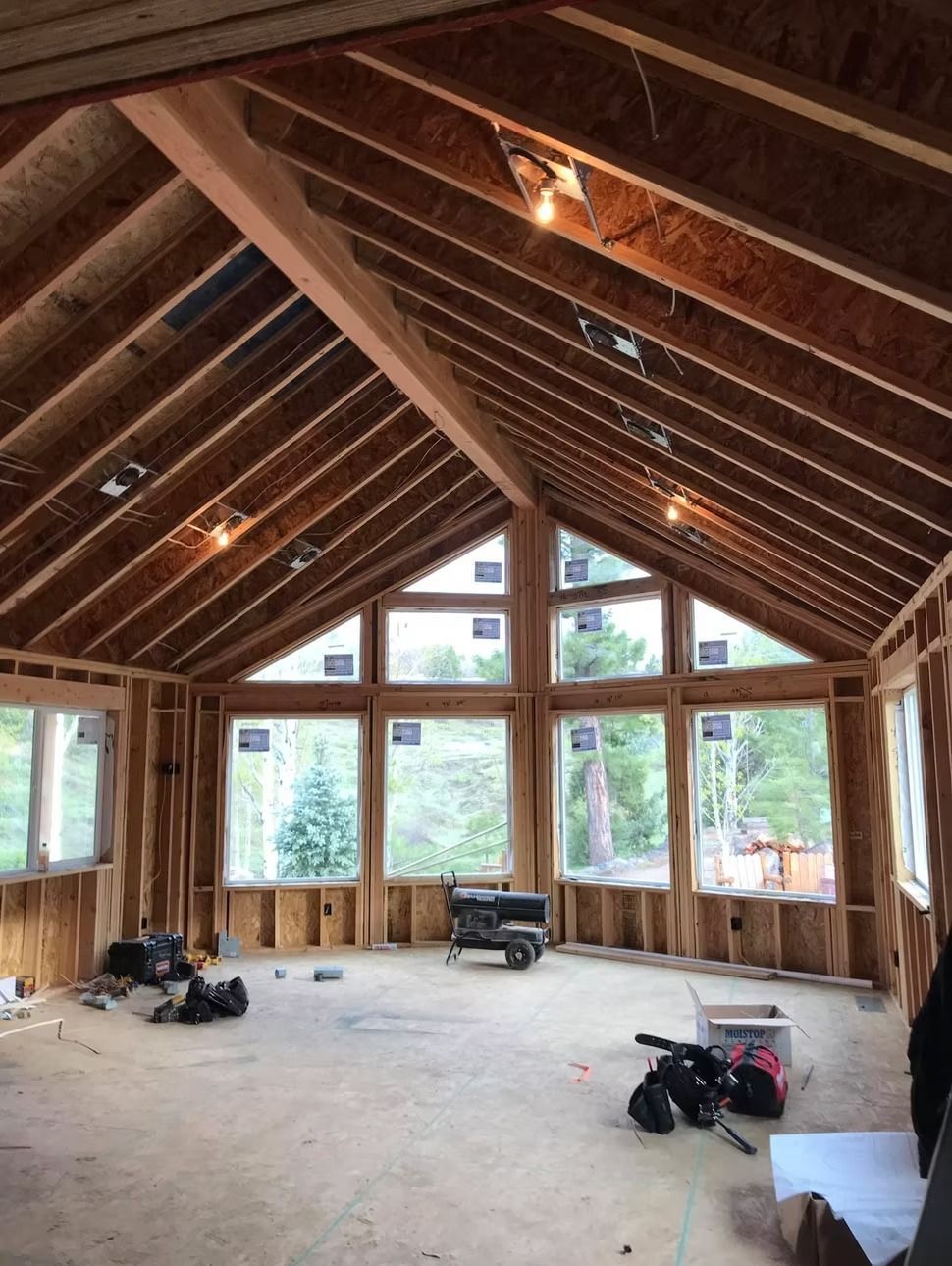 A large room with a vaulted ceiling and lots of windows
