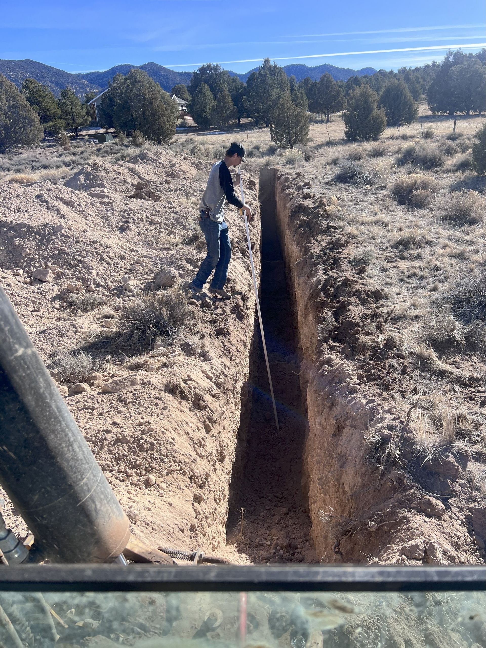 A pipe is sticking out of the ground in the dirt.