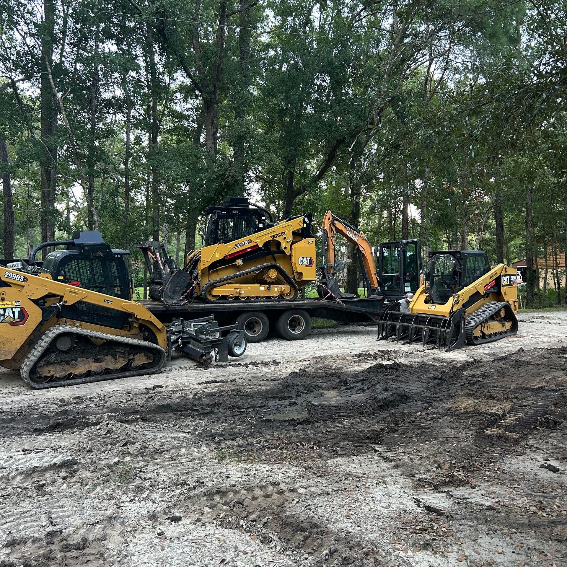 Two trucks are parked on the side of the road in a parking lot.