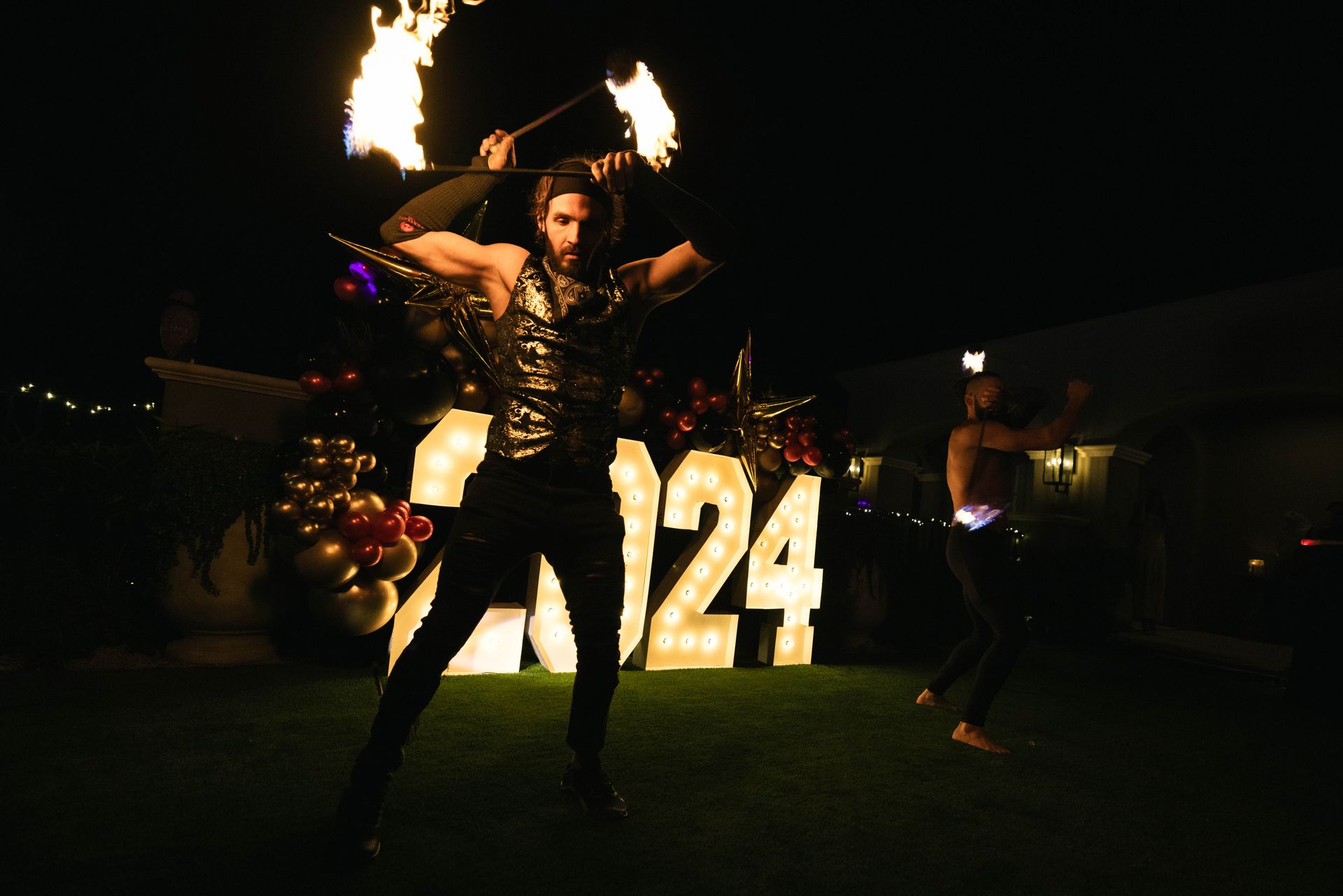 A man is holding a fire stick in front of a sign that says 1234.