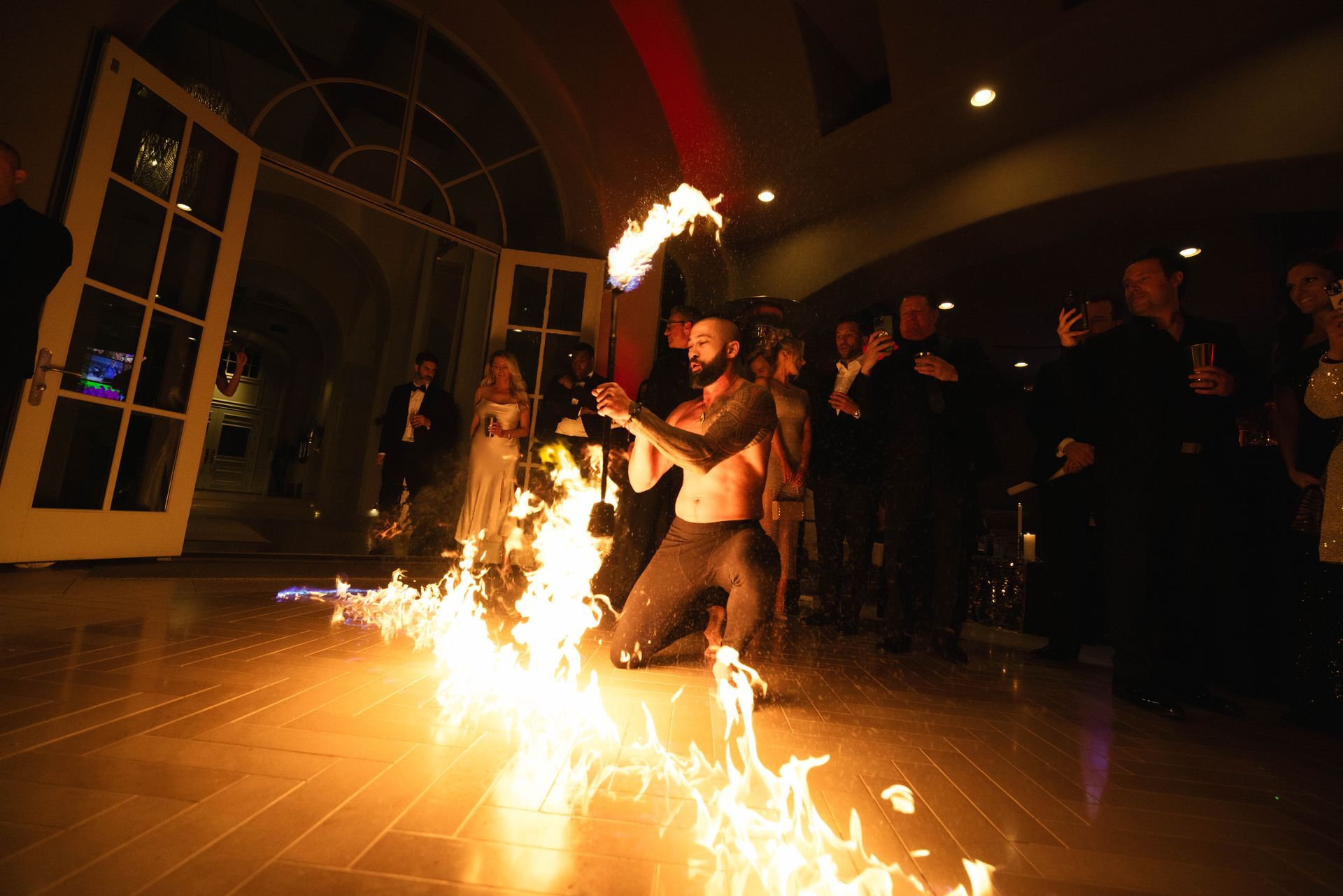 A man is kneeling down in front of a fireball.