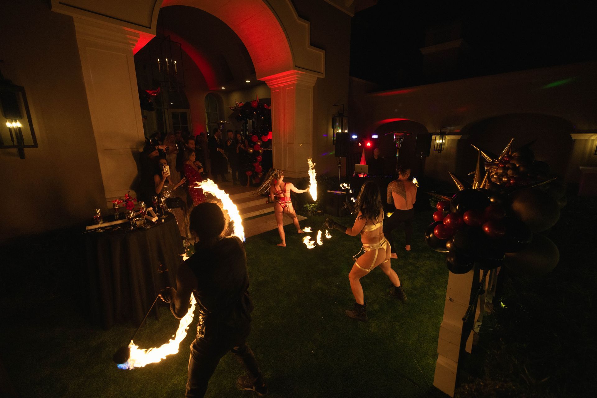 A group of people are playing with fire in a dark room.