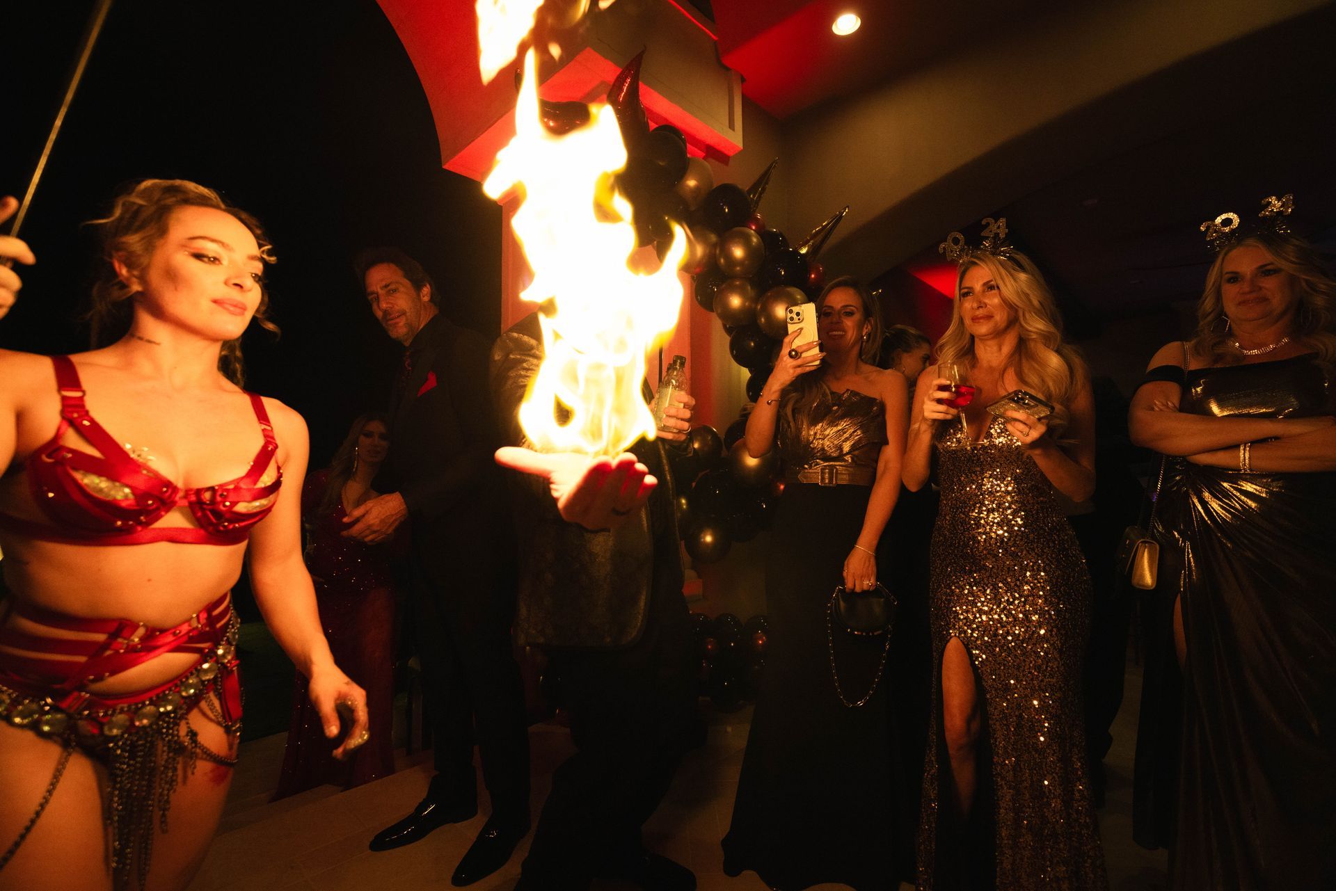 A group of people are standing around a fire torch.