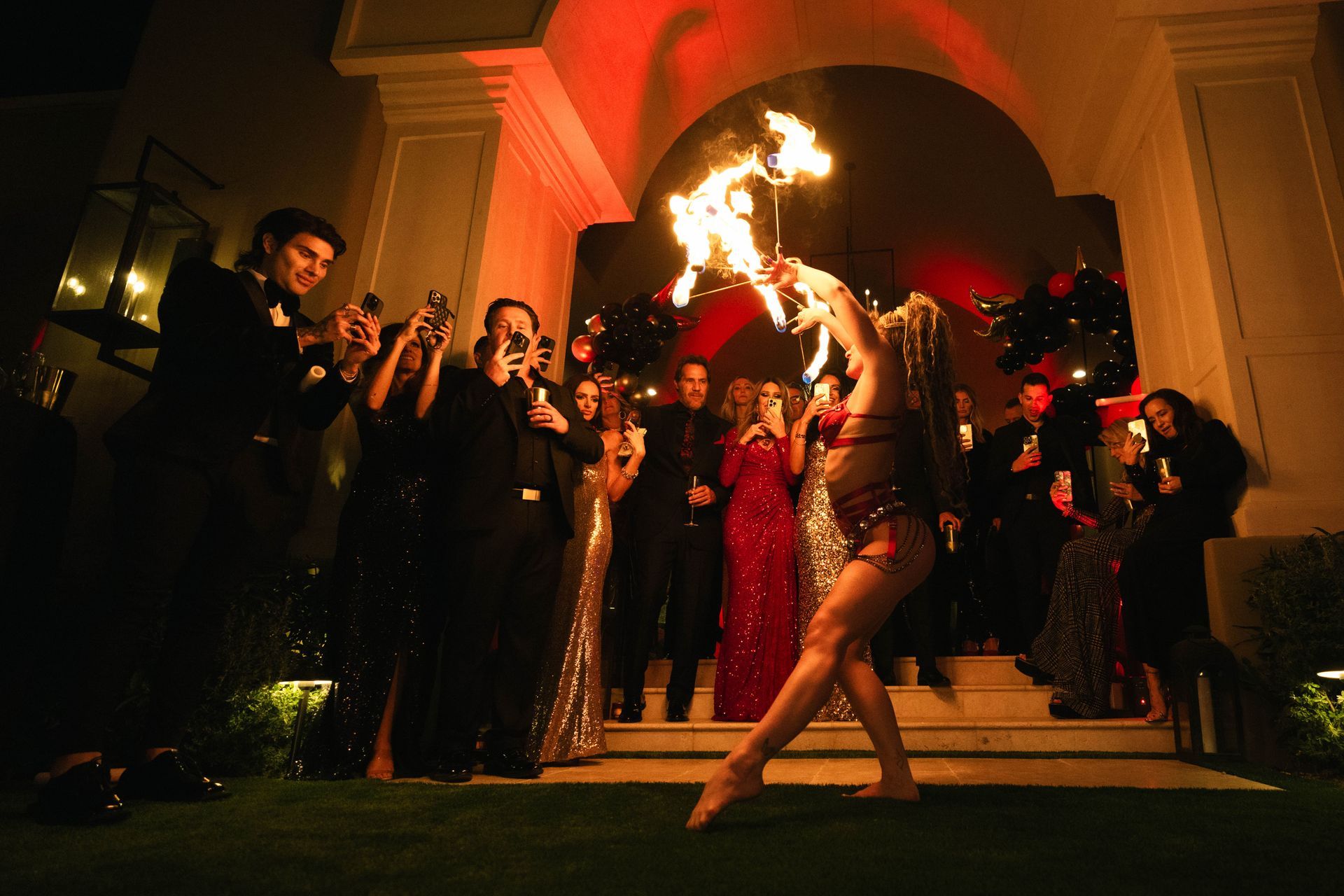 A woman is holding a torch in front of a crowd of people.