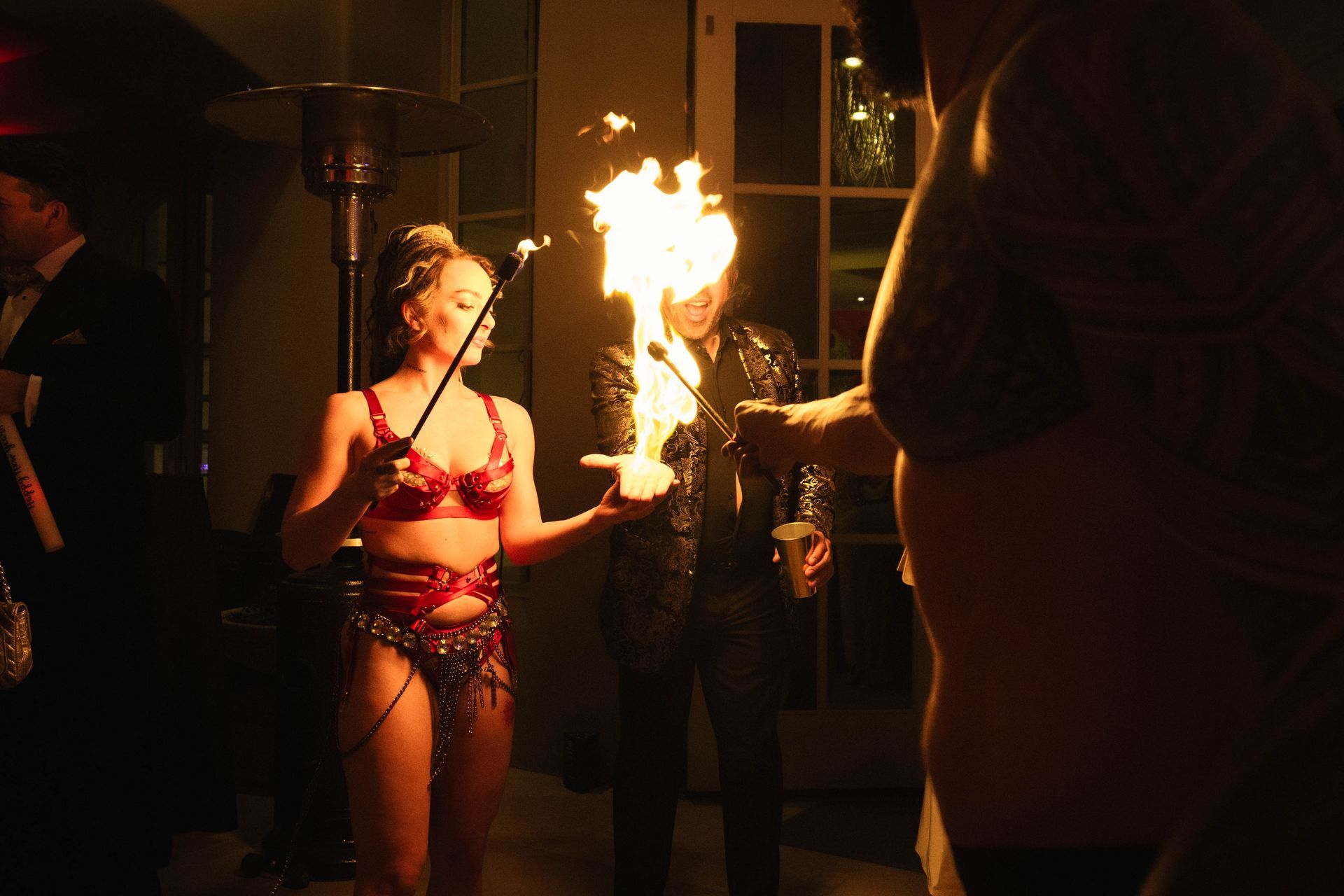 A woman is holding a torch with flames coming out of it