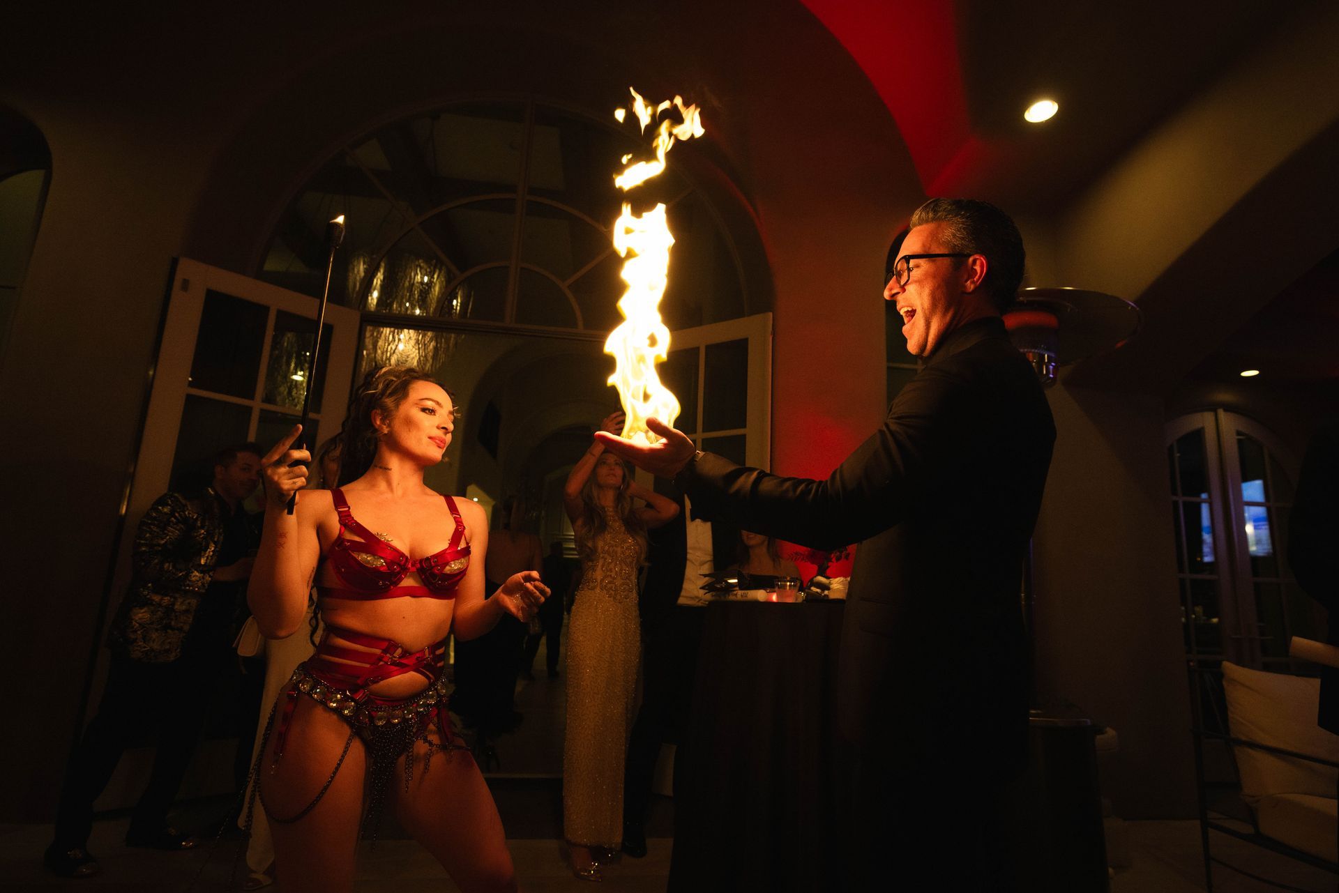 A man is holding a torch in front of a woman in lingerie.