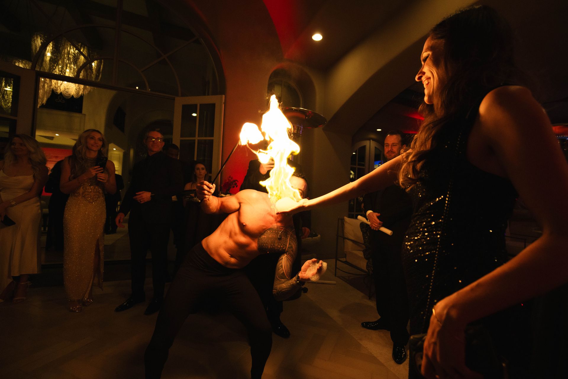 A man is holding a torch in his hand while a woman watches.